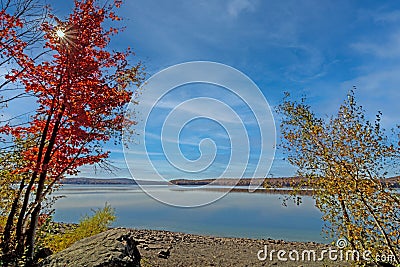 Lake Wallenpaupack in Poconos PA on a bright fall day lined with trees Stock Photo