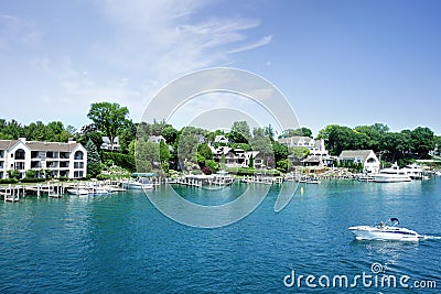 Lakefront homes and boats in the Round Lake in downtown Charlevoix Michigan Stock Photo