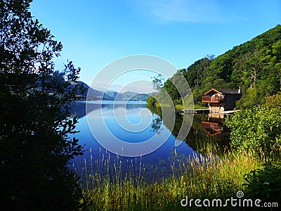 Beautiful scenic lakeside view with boathouse Stock Photo