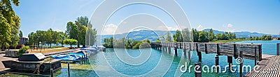 Lakeside Zurichsee with moored boats, wooden bridge, tourist destination Rapperswil-Jona Stock Photo