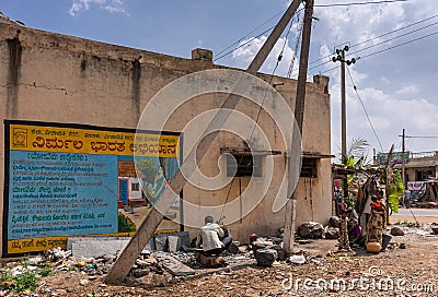 Hygiene poster, hand-made mortars and family in Lakundi, Karnataka, India Editorial Stock Photo