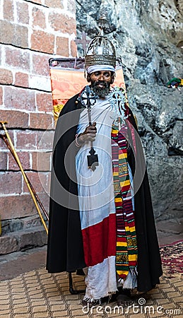 Lalibela, Ethiopia - Feb 14, 2020: Ethiopian priest at the famous Monastery Neakuto Leab near Lalibela in Ethiopia Editorial Stock Photo