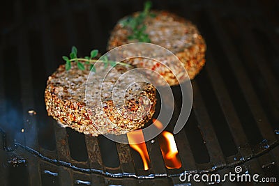 Lamb burgers spiced by lamb rub on bbq grill with flame Stock Photo