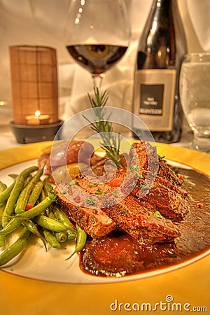 Lamb entree dinner with wine in a fine dining restaurant Stock Photo