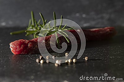 LAMB FILE WITH ROSEMARY ON BLACK BACKGROUND. MEAT AND PEPPER GASTRONOMY PHOTO Stock Photo