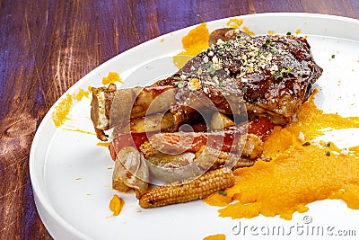 Lamb shank with demiglas sauce, carrot puree with caramelized vegetables Stock Photo