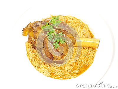 Lamb shank in juicy yellow rice Stock Photo