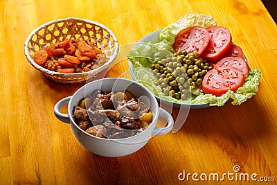 Lamb stewed with potatoes in spices and sauce next to dried fruits and vegetables iftar Stock Photo