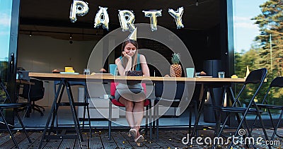 Lame birthday party on quarantine. Sad upset Caucasian young beautiful woman sits alone at home with cake slow motion. Stock Photo