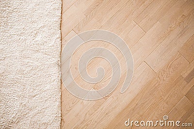 Laminate parquete floor with beige soft carpet Stock Photo