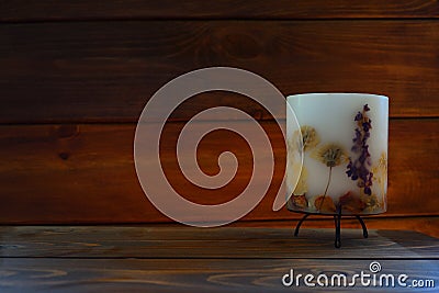 Lamp with a candle on a brown lined wall background Stock Photo