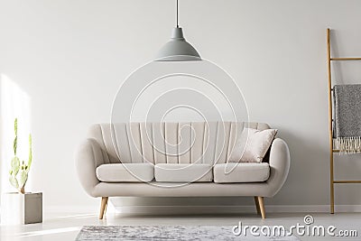 Lamp hanging above couch Stock Photo