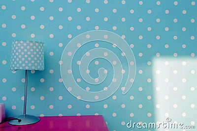 Lamp night light with blue wall and white dots wallpaper, colorful room for child modern design pink table. Stock Photo