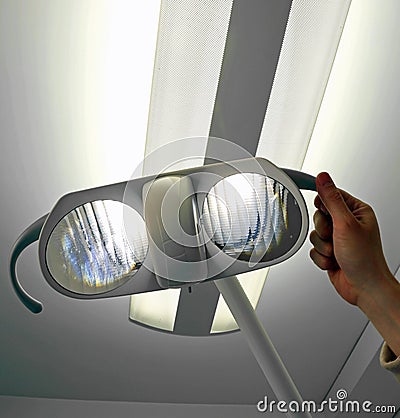 Lamp of an operating room and the hand of the doctor Stock Photo