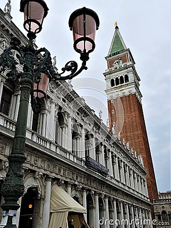 Lamppost with Venetian Glass and St. Mark`s Campanile Editorial Stock Photo