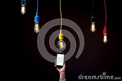 Lamps in colorful plafonds with smart phone Stock Photo