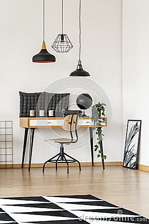 Lampshades above desk Stock Photo