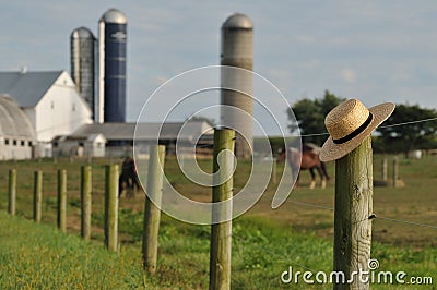 Lancaster Amish farm with straw hat Stock Photo