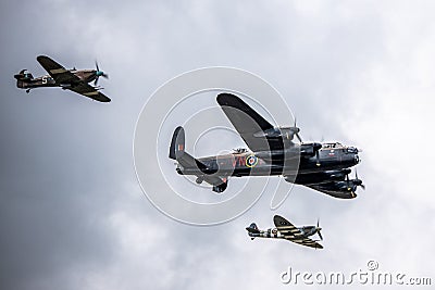 Lancaster bomber with a hurricane and spitfire flying beside it from below Stock Photo