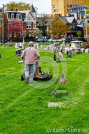Working Cutting Grass in Cemetery Editorial Stock Photo