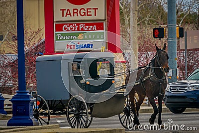 LANCASTER, USA - APRIL, 18, 2018: View of amish carriage along the city, known for simple living with touch of nature Editorial Stock Photo