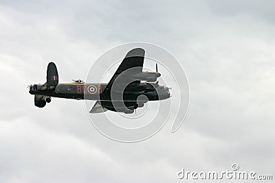 Lancaster WW2 bomber in a cloudy sky. Editorial Stock Photo
