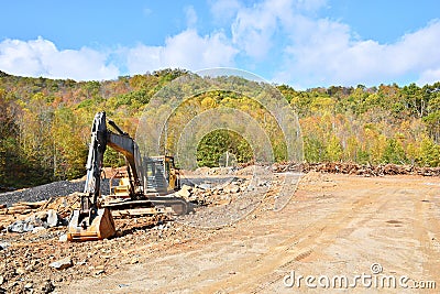 Land cleared by machinery with large back-hoe Stock Photo