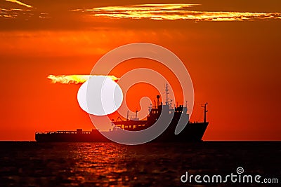 Land of midnight sun. Full sun and orange sky over tropical East Stock Photo