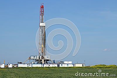 Land oil drilling rig on green field Stock Photo