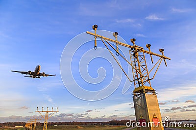 Landing aircraft over landing lights Stock Photo