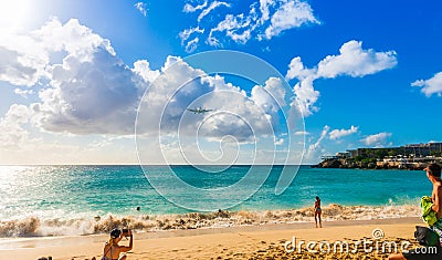 Landing of an airplane at Princess Juliana Airport from Maho Beach on the island of Saint Martin in the Caribbean Editorial Stock Photo
