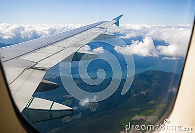Landing in the city of Vancouver. Aerial view. Buildings, houses, river. Sunny day and cloudy sky. Stock Photo