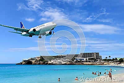 Landing plane at Maho Beach, Saint Martin Editorial Stock Photo