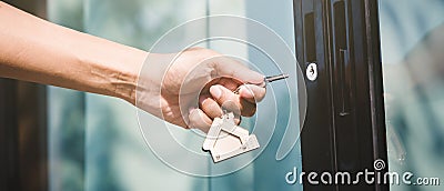 Landlord unlocks the house key for new house Stock Photo