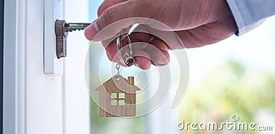 Landlord unlocks the house key for new home Stock Photo