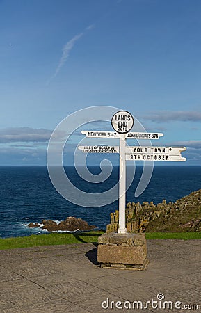 Lands End Cornwall England UK signpost blue sea and sky Stock Photo