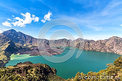 Landscape of active volcano Baru Jari, Lake Segara Anak and summit of Rinjani mountain. Lombok island, Indonesia Stock Photo