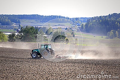Landscape with Agricultural Tractor Cultivating Field Stock Photo