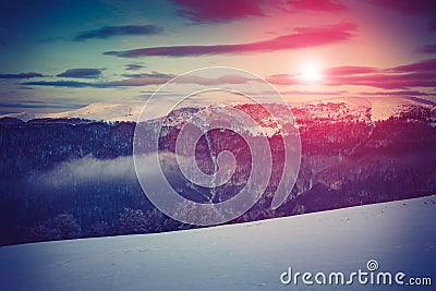 Landscape of amazing evening winter in mountains. Fantastic evening glowing by sunlight. Stock Photo