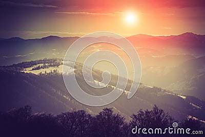 Landscape of amazing evening winter in mountains. Fantastic evening glowing by sunlight. Stock Photo