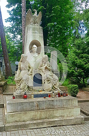 Landscape.The ancient crypt of white stone. Two girls are depicted near the monument with the head of a man. On the monument sits Stock Photo