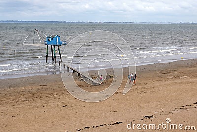 Landscape of the Atlantic shore in France with huts on stilts in the sea Editorial Stock Photo