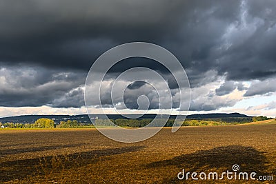 landscape in autumn, dark clouds and golden sun over agrultural fields near Göttingen, Germany Stock Photo