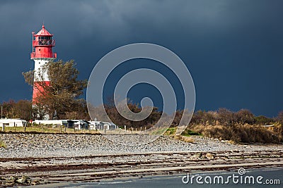 Landscape baltic sea dunes lighthouse in red and white Stock Photo