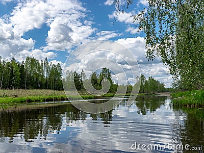 Landscape with a beautiful river in spring, cloud reflections in the water Stock Photo
