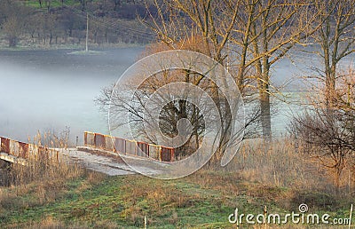 Landscape with a bridge over a river and fog Stock Photo