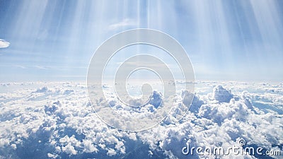 Landscape of clouds and sunbeams seen from above from an airplane windows Stock Photo