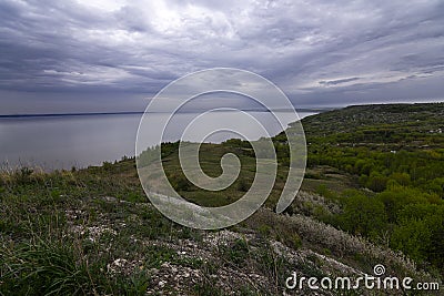 Landscape in cloudy weather. River, coast, forest Stock Photo