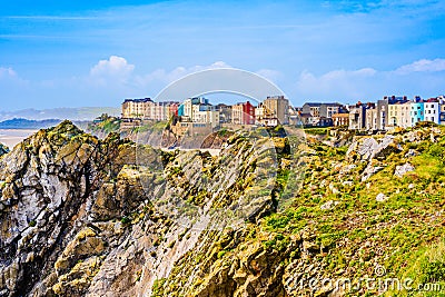 Landscape of colorful houses behind cliffs in Tenby a harbour town and resort in Pembrokeshire, southwest Wales, UK Stock Photo