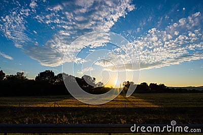 Landscape of cultivated fields and farms with mountain range in the background. Irrigation system for industrial agriculture. Back Stock Photo